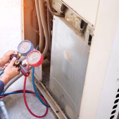 Technician is checking air conditioner ,measuring equipment for filling air conditioners.